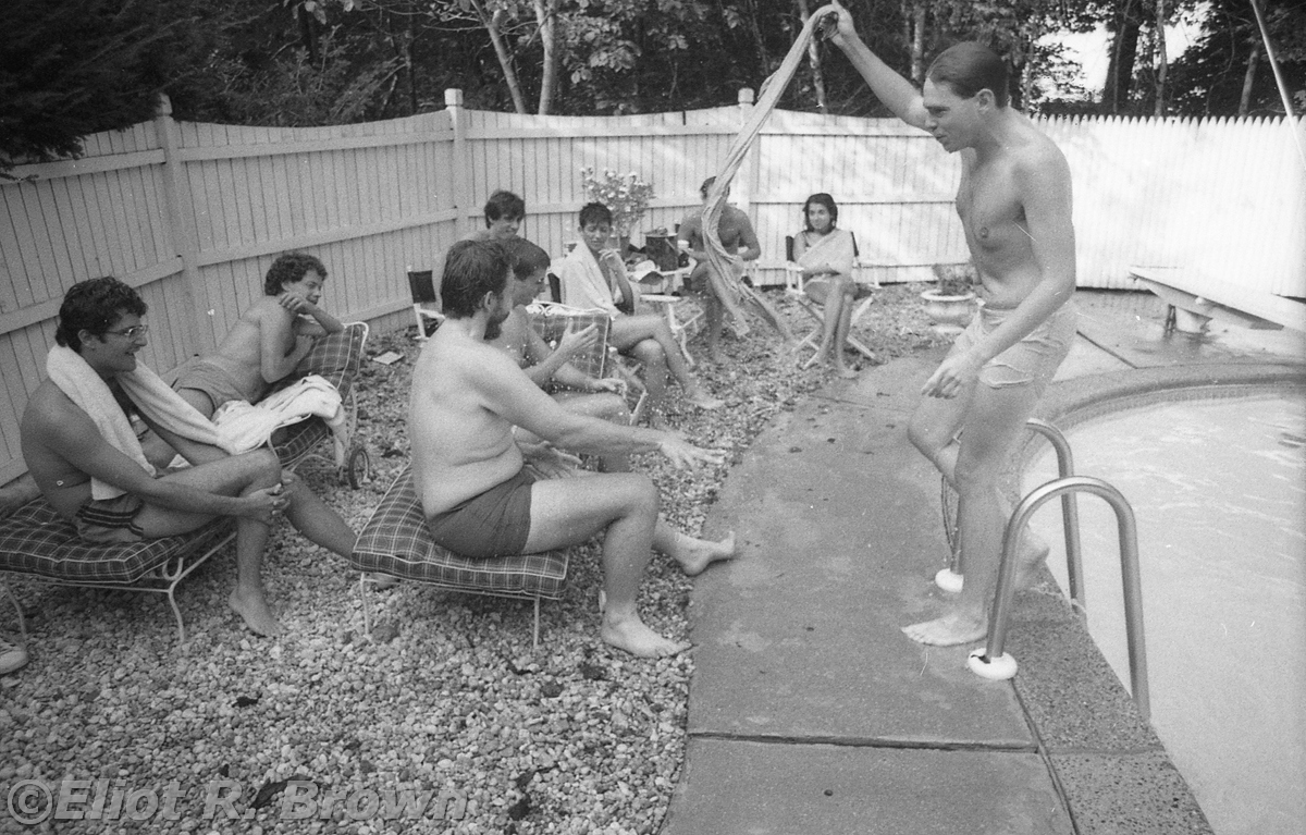 Pool-side antics! L-R Ralph, ahem, Editor Raf, Senior Editor Special Projects Bob Budianski, Writer/Creator Peter Gillis (who has of late taken to adding a middle name Peter Benno Gillis; Pete was the other unsung genius (Peter Sanderson being the other) of comics, theorizing and philosophizing epic story lines and character backgrounds… which kind’a sounds like I’m describing the Marvel Universe encyclopedic effort. And I am, both Peters were instrumental in advising and consenting that tome’s content along with Mark Gruenwald. Of personal note, when I as tech illustrator needed either background info, these guys could summon everything needed; further, they could deliver up the most perfect image reference. Often only one image did it.), Editor Bob Harris way in the back of the triple-head line-up, Jack getting a towel full from Mike, Lisa Hach then Mark Gru with the towel in front of him and finally Editrix Extraordinaire Annie Nocenti. That’s the sitting run down—standing is lean-as-a-bean Mike Carlin!